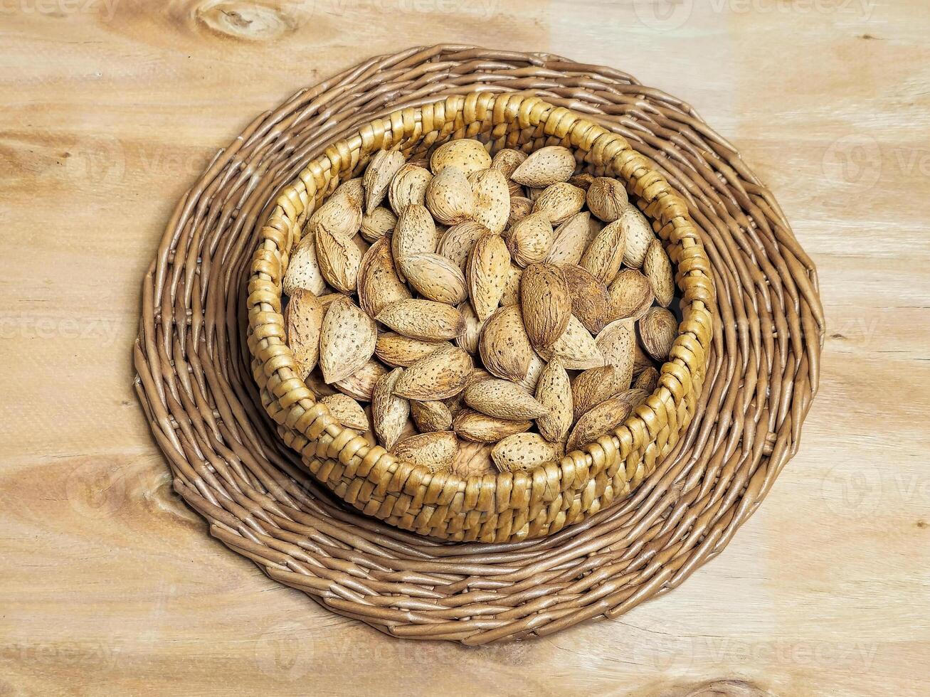 Close up inshell almonds in a wicker bowl photo
