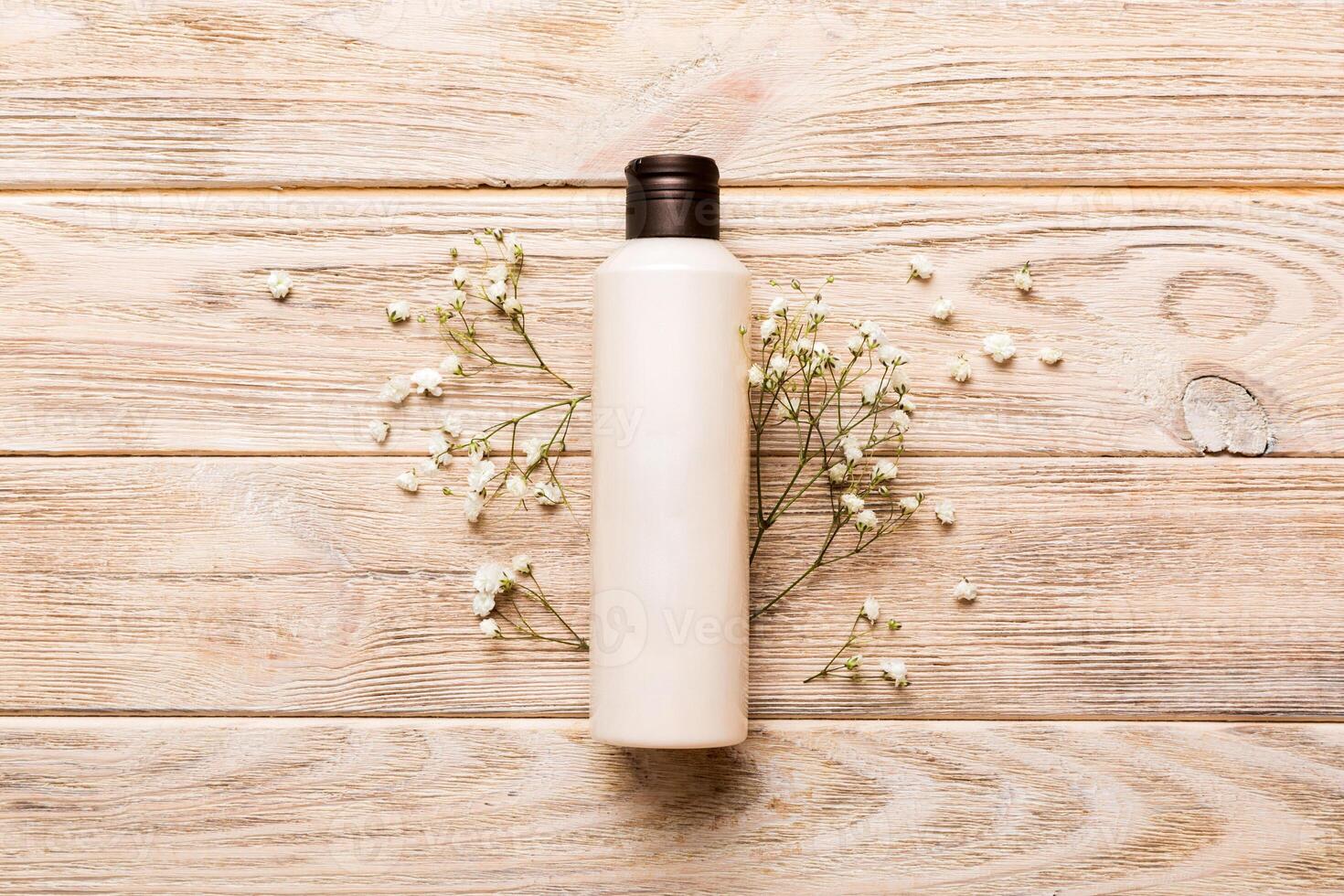 Fancy healthcare bottles for cream with gypsophila branch. Natural oranic spa cosmetics concept. Mockup, template, photo