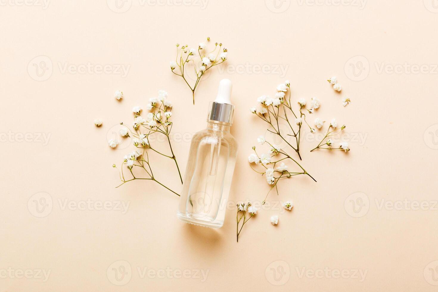 Fancy healthcare bottles for serum, micellar, tonic, lotion, water and cream with gypsophila branch. Natural oranic spa cosmetics concept. Mockup, template, Top view photo
