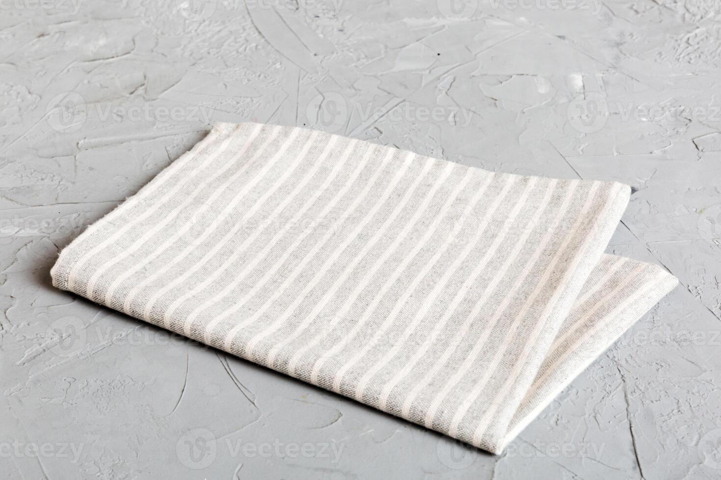 top view with gray kitchen napkin isolated table background. Folded cloth for mockup with copy space, photo