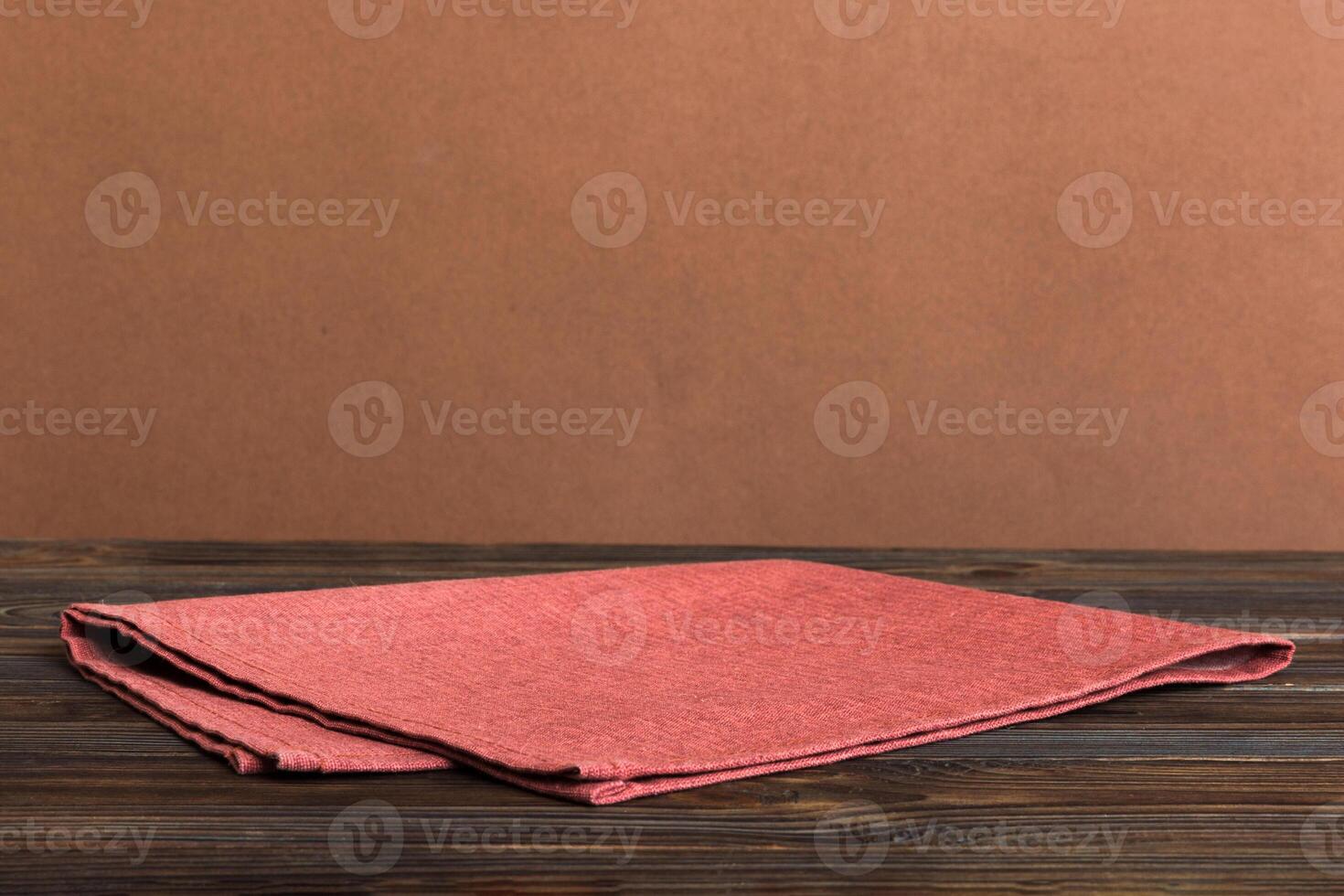 top view with red empty kitchen napkin isolated on table background. Folded cloth for mockup with copy space, style photo