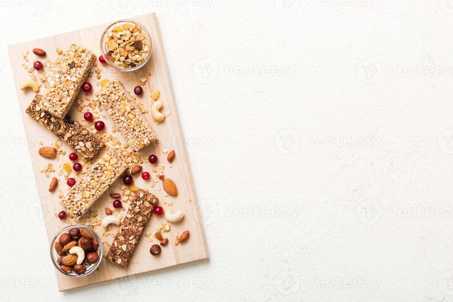 Various granola bars on table background. Cereal granola bars. Superfood breakfast bars oats, nuts and berries. Superfood concept photo