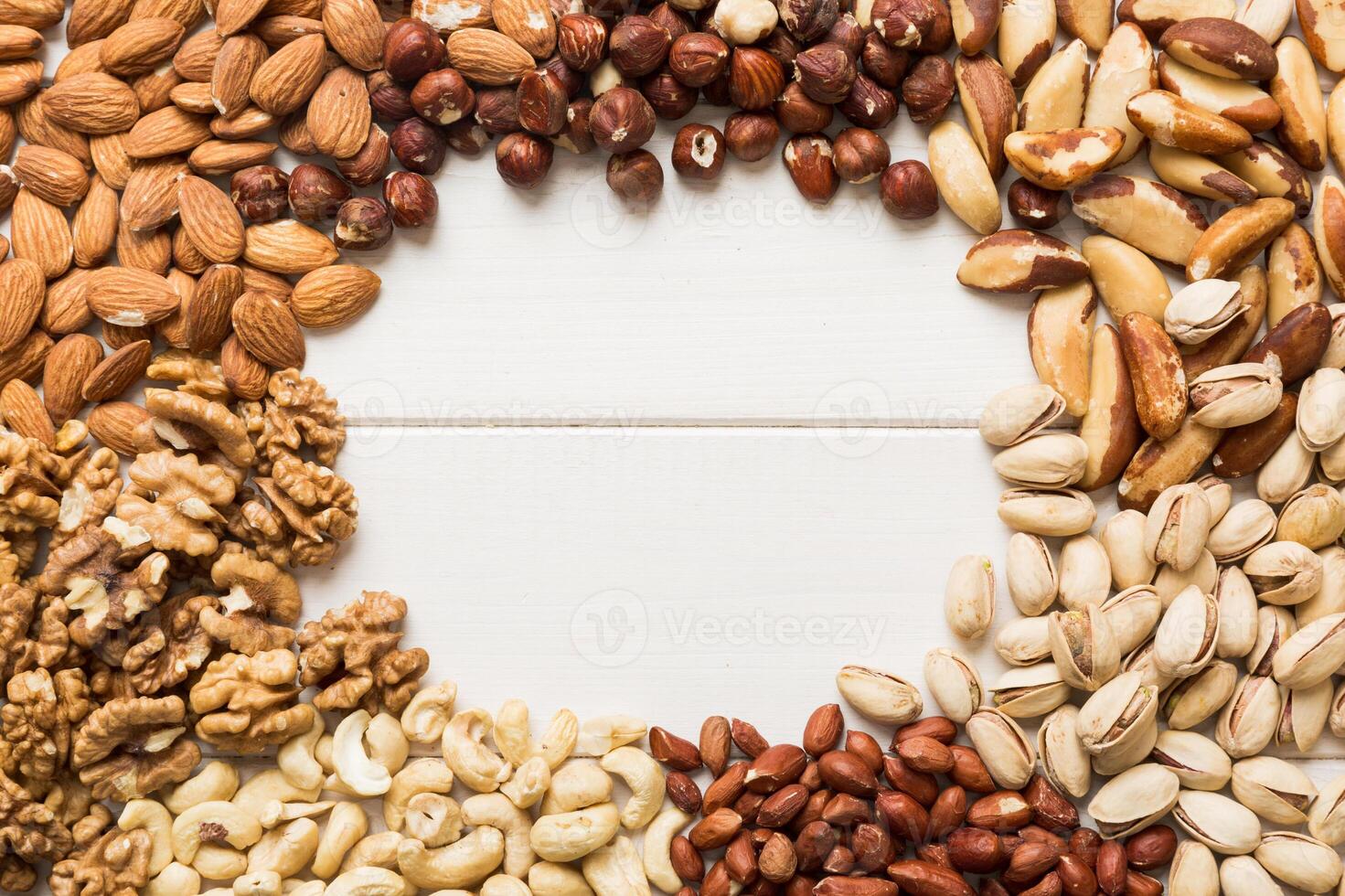 different nuts frame background. with vopy space. Walnut, pistachios, almonds, hazelnuts and cashews photo