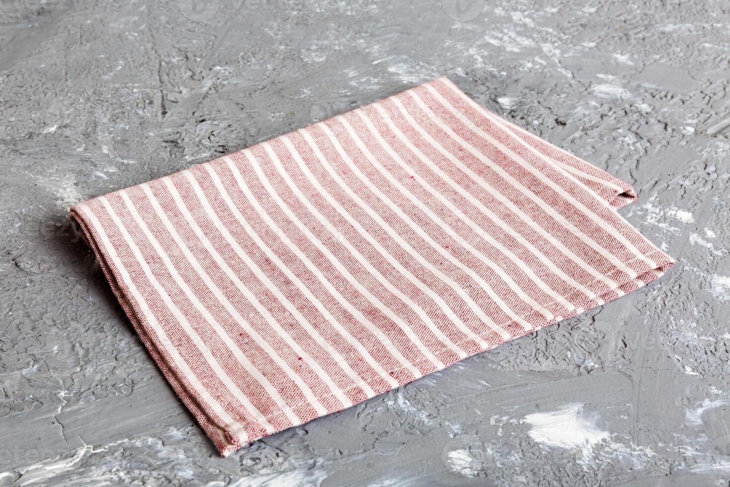 top view with red empty kitchen napkin isolated on table background. Folded cloth for mockup with copy space photo