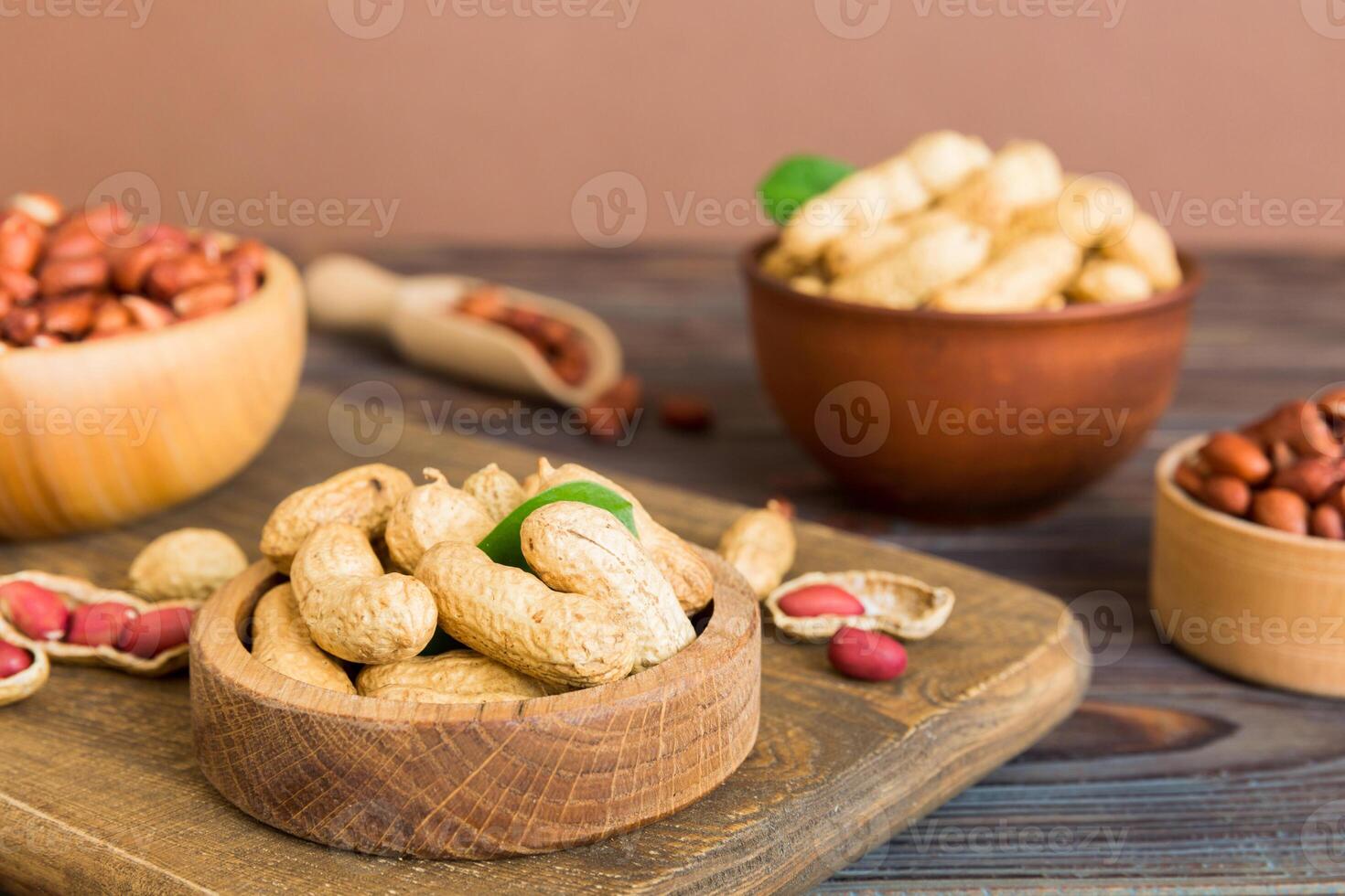 Fresh healthy peanuts bowl on colored table background. Top view Healthy eating bertholletia concept.Super foods photo