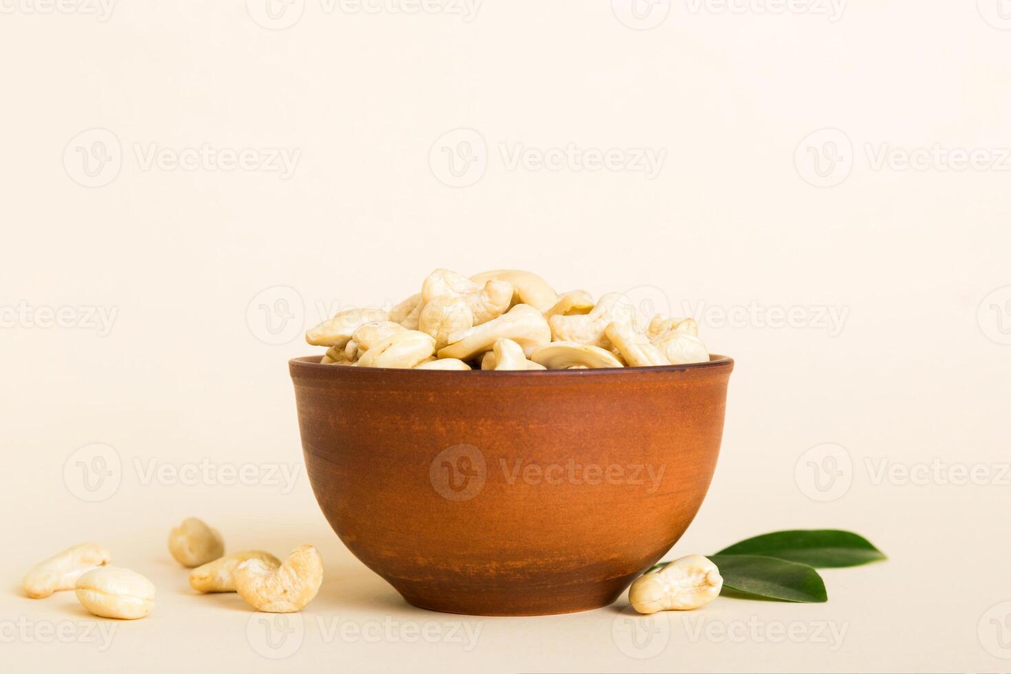 cashew nuts in wooden bowl table background. top view. Space for text Healthy food photo