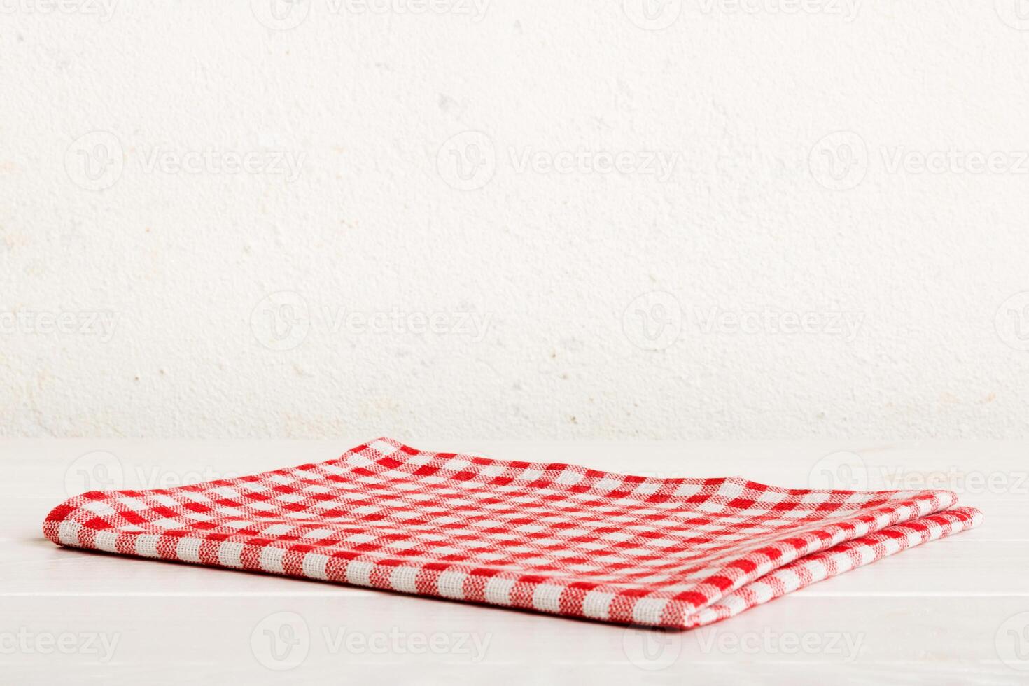 top view with red empty kitchen napkin isolated on table background. Folded cloth for mockup with copy space, photo