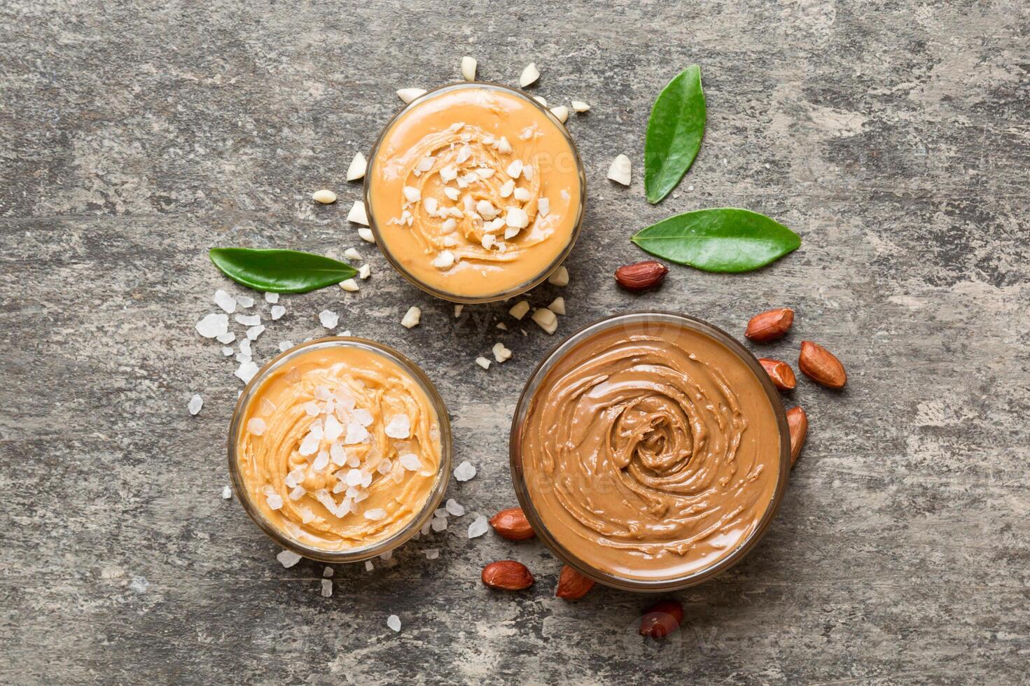 Glass jar with peanut butter table background, top view space for text and close up photo