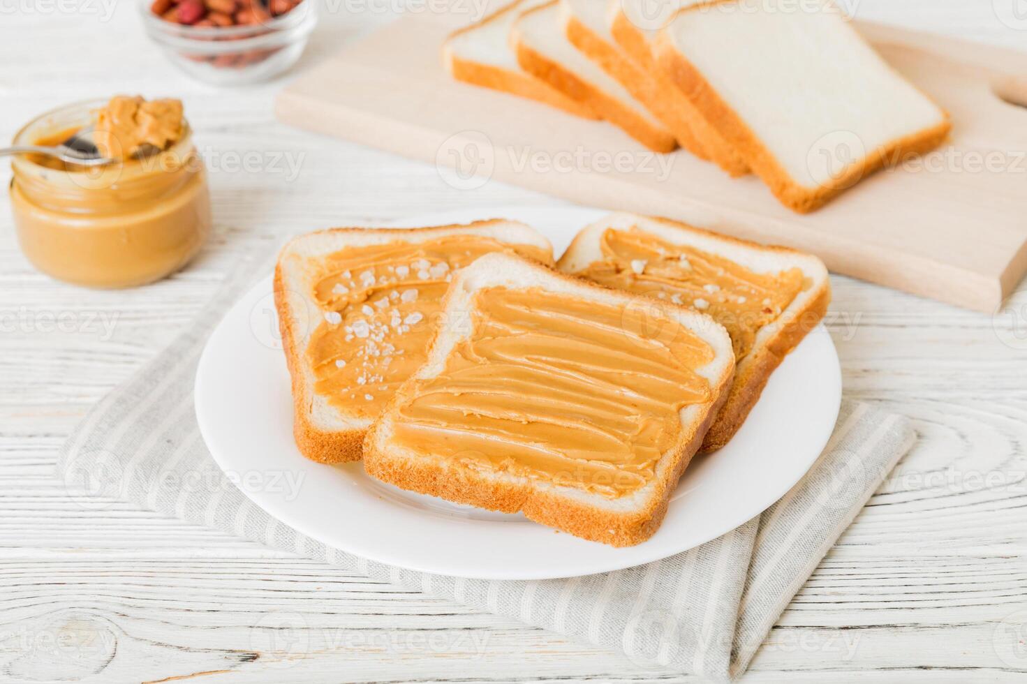 Peanut butter sandwiches toasts on light table background.Breakfast. Vegetarian food. American cuisine top view vith copy space photo