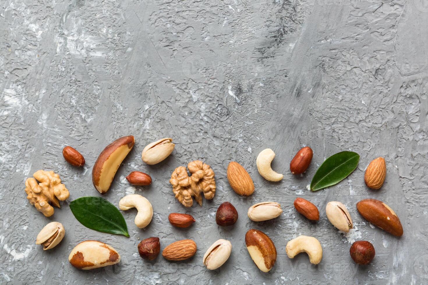 Composition nuts , flat lay mix hazelnuts, cashews, almonds on table background. healthy eating concepts and food background photo