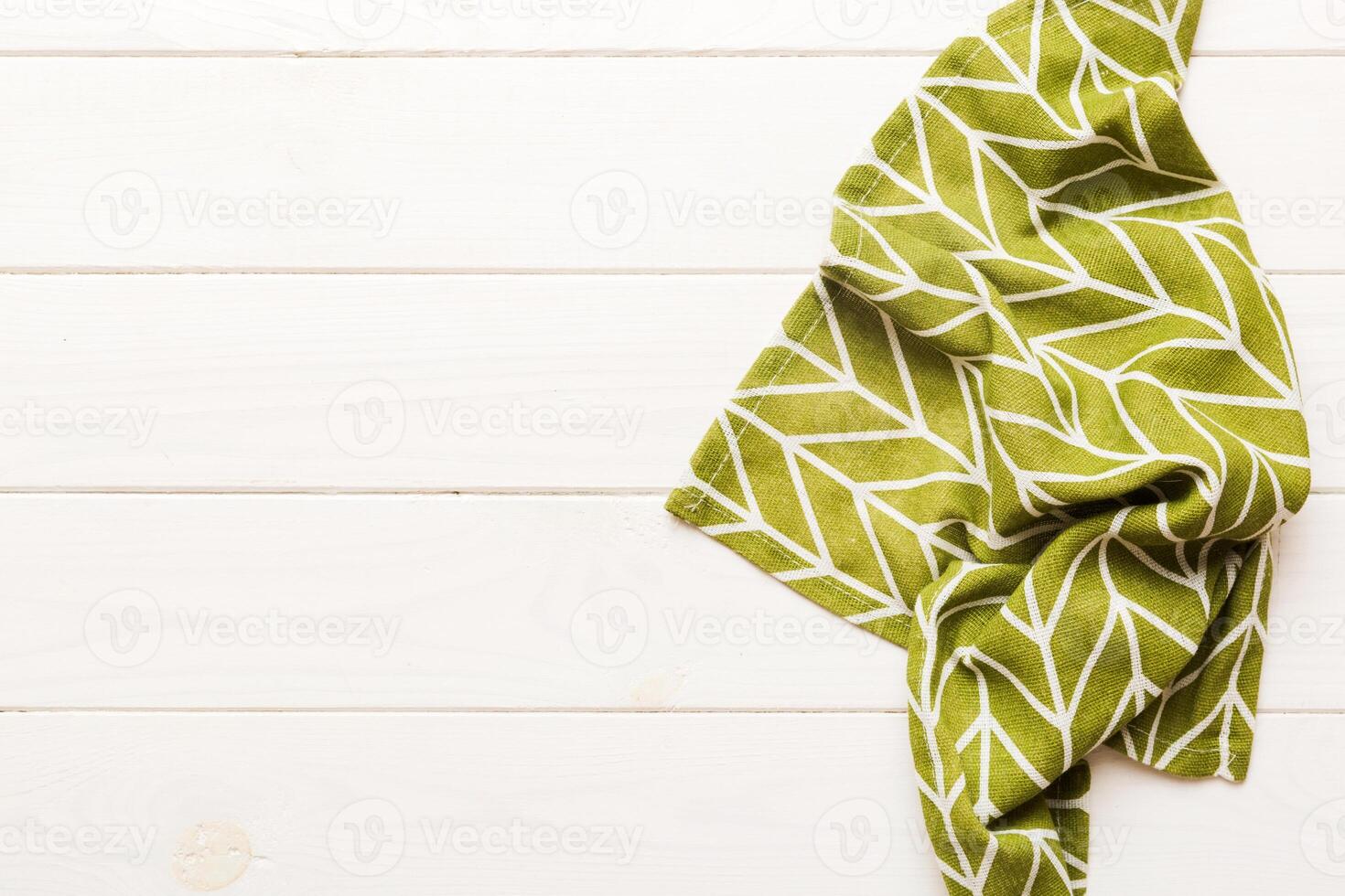 top view with green kitchen napkin isolated on table background. Folded cloth for mockup with copy space, photo