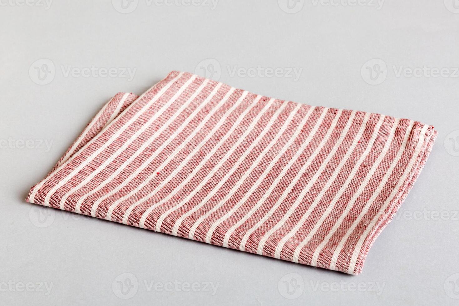 top view with red empty kitchen napkin isolated on table background. Folded cloth for mockup copy space, Minimal style photo