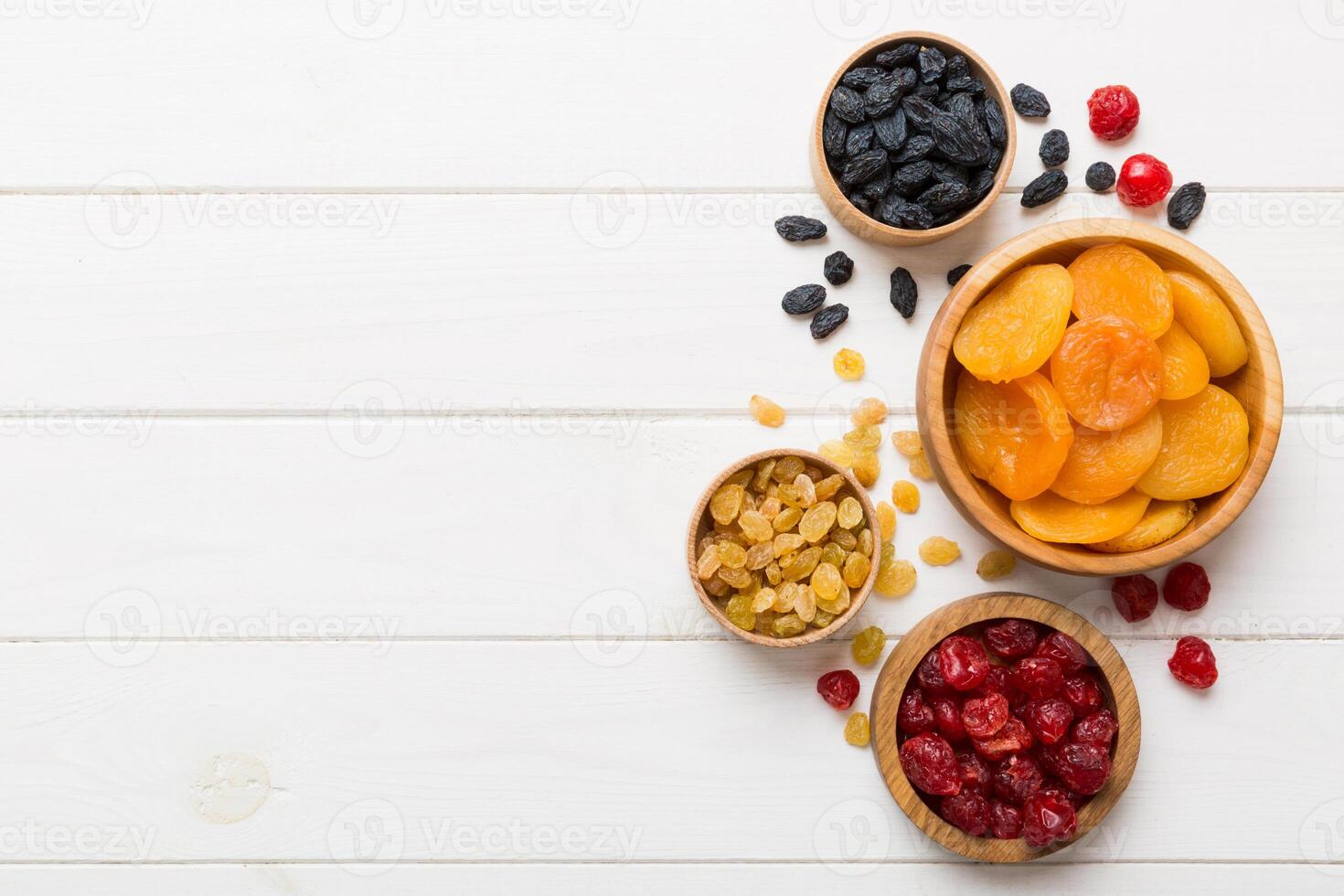 Bowl different dried fruits table background, top view. Healthy lifestyle with copy space photo
