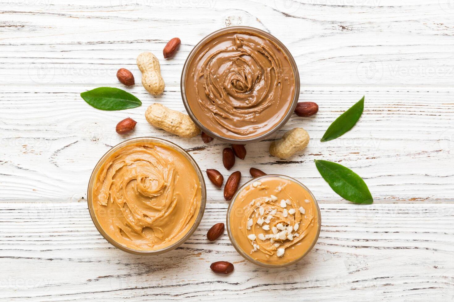 Glass jar with peanut butter table background, top view space text and close up photo
