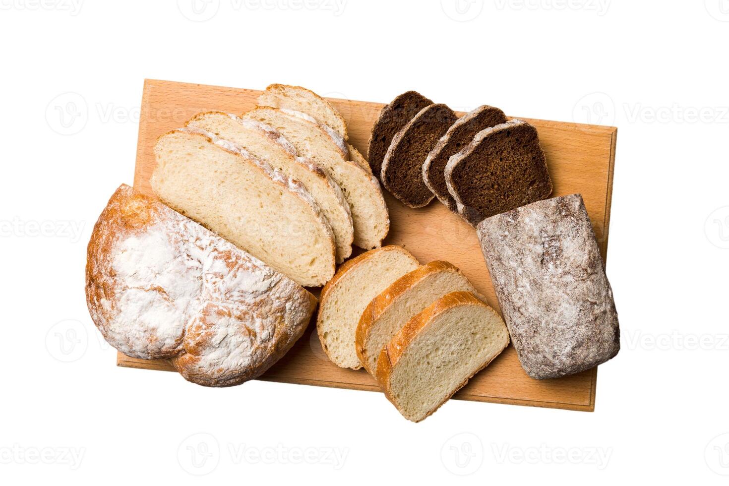 Freshly baked bread slices cutting board isolated on white background . Sliced bread photo