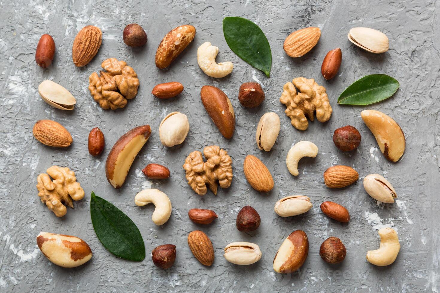 Composition nuts , flat lay - mix hazelnuts, cashews, almonds on table background. healthy eating concepts and food background photo