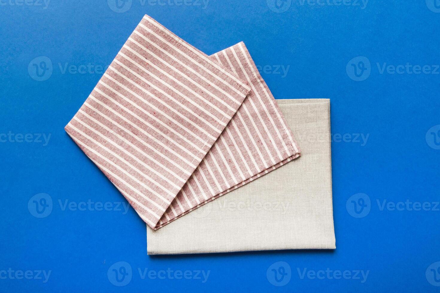 top view with red empty kitchen napkin isolated on table background. Folded cloth for mockup copy space, Flat lay. Minimal style photo