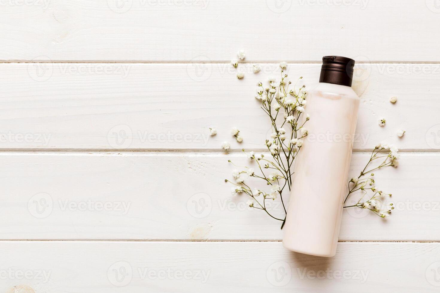 Fancy healthcare bottles for cream with gypsophila branch. Natural oranic spa cosmetics concept. template, Top view photo