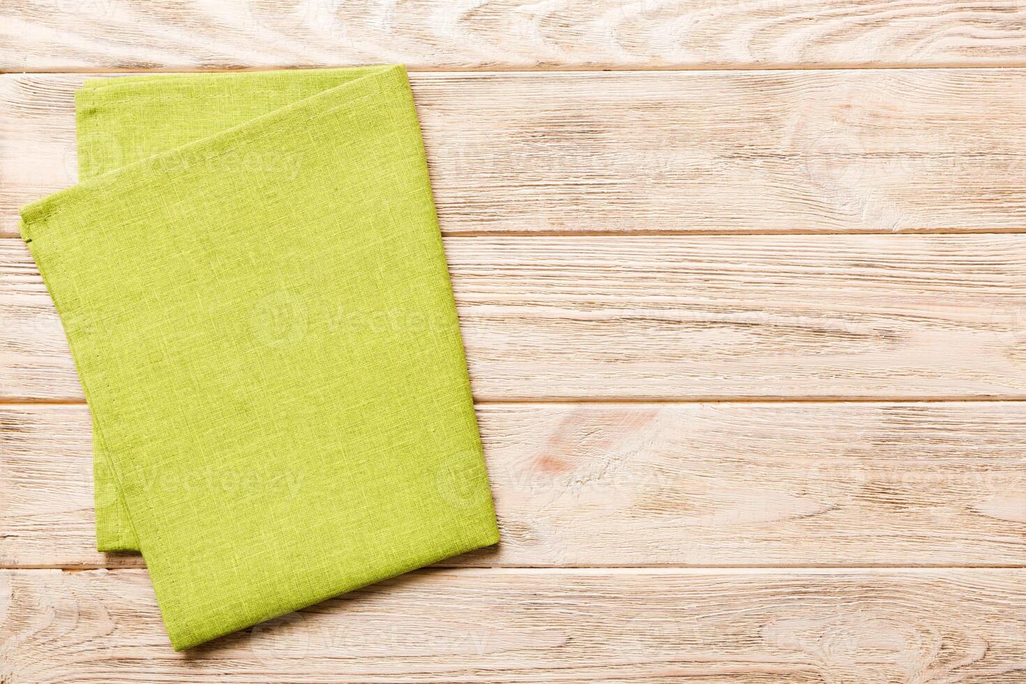 top view green kitchen napkin isolated on table background. Folded cloth for mockup with copy space, Flat lay. Minimal style photo
