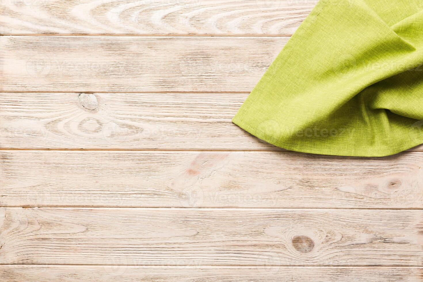 top view with green kitchen napkin isolated on table background. Folded cloth for mockup with copy space. Minimal style photo