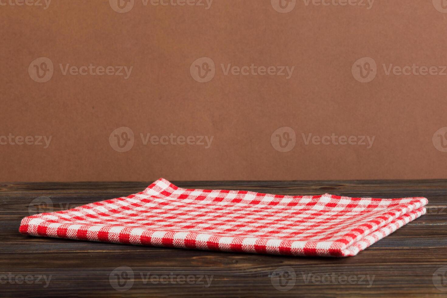 top view with red empty kitchen napkin isolated on table background. Folded cloth for mockup with copy space. Minimal style photo