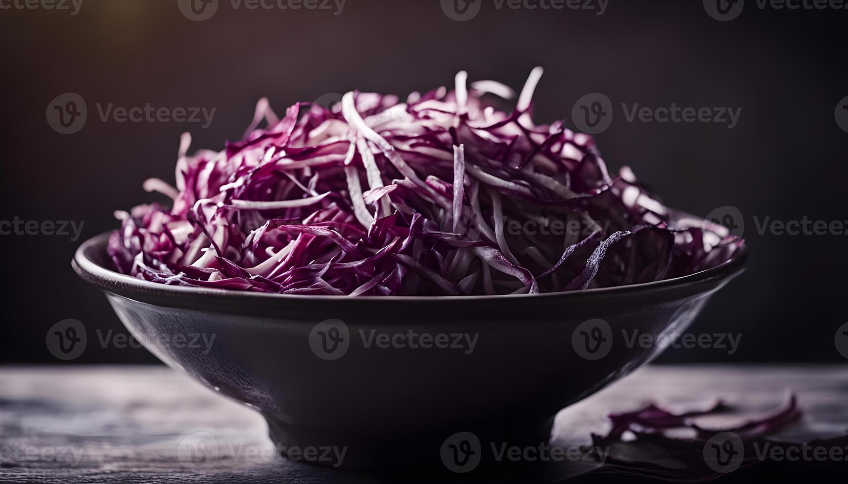 Closeup macro shot of shredded cabbage in bowl, black background for contrast. photo