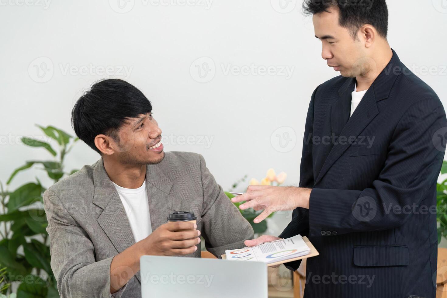 Business Meeting and Collaboration. Two professionals discussing ideas in a modern office environment. photo