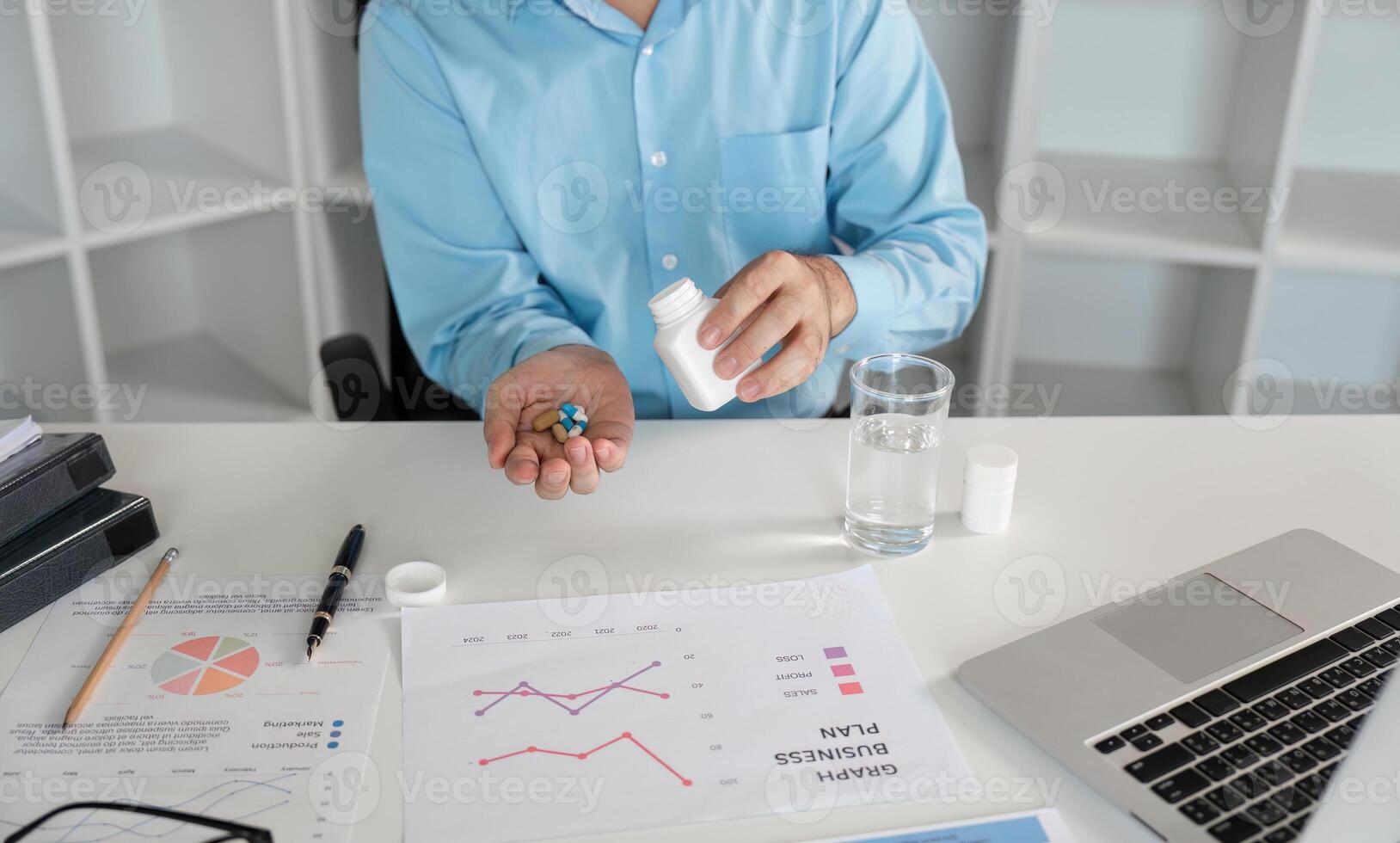 Office Worker Feeling Unwell with Cold Symptoms at Desk with Medication and Business Documents in Modern Workspace photo