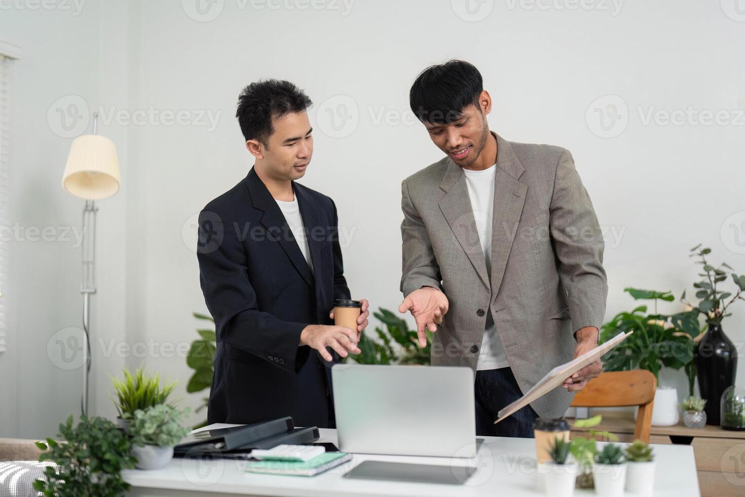 Business Collaboration and Teamwork. Two professionals discussing ideas in a modern office setting. photo