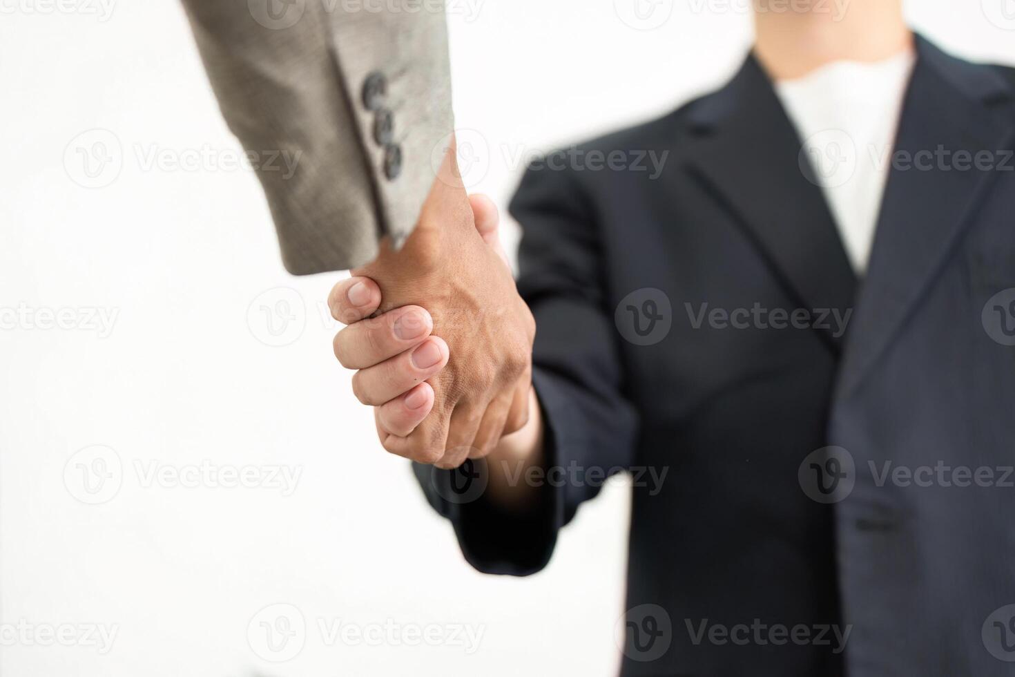 Handshake and Professionalism. Close-up of two business partners sealing a deal with a firm handshake. photo