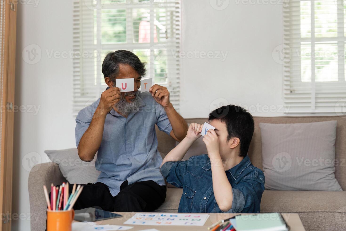 Engaging Learning Activities. A grandfather and his grandson with Down syndrome enjoy educational play. photo