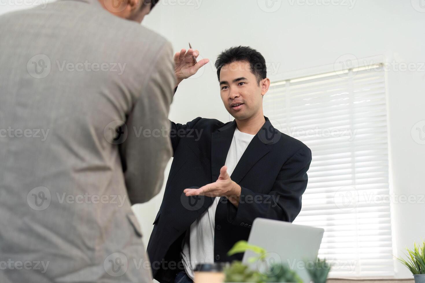 Engaging Presentation and Idea Sharing. A professional explaining project concepts to a colleague in a modern office. photo