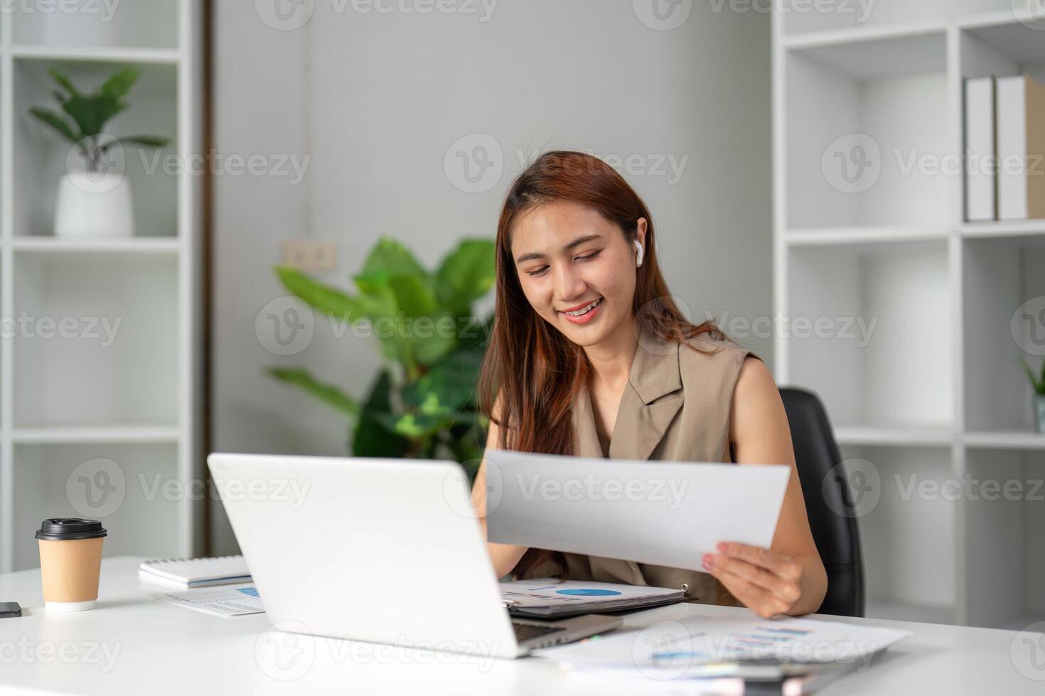 Work Online and Document Review. A young professional highlights documents with satisfaction while immersed in remote work. photo