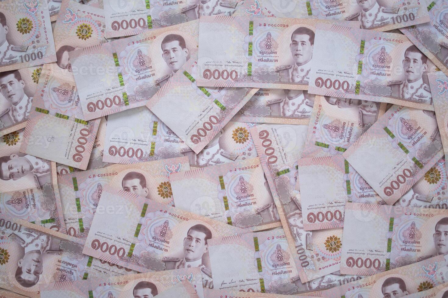 Thai currency , Many THAI bank notes Placed on the table.The Baht is the currency of Thailand that is used to change, buy, sell, accumulate, and invest in Thailand stock. photo