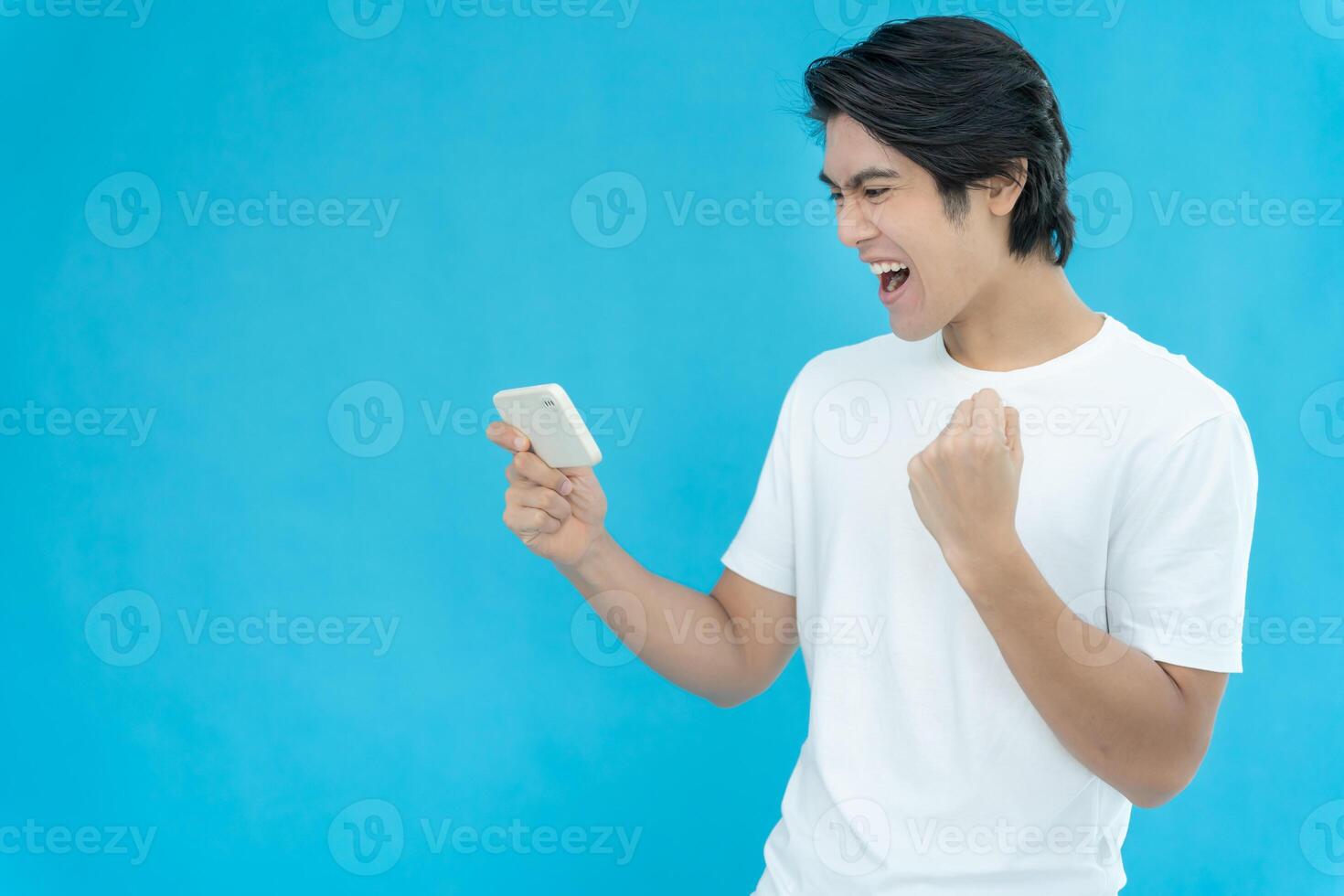 Asian handsome man exited surprise face expression . Male feels shocked with the phone. exciting smile and happy adorable rejoices, Very enjoy and fun relax time. wow, girl holding smartphone. photo