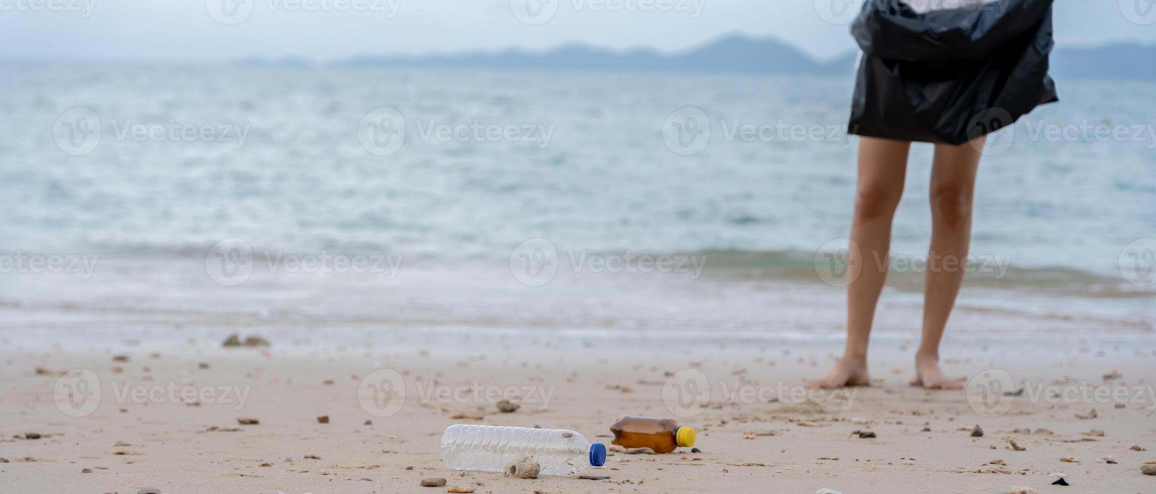 Save water. Volunteer pick trash garbage at the beach and plastic bottles are difficult decompose prevent harm aquatic life. Earth, Environment, Greening planet, reduce global warming, Save world photo