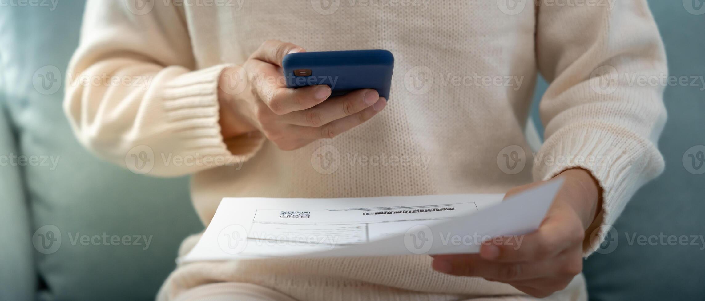 Modern woman use phone to scan barcode or QR codes to pay credit card bill after receive document invoice. payment, receive, paying electricity, digital payments without money technology, scanning photo