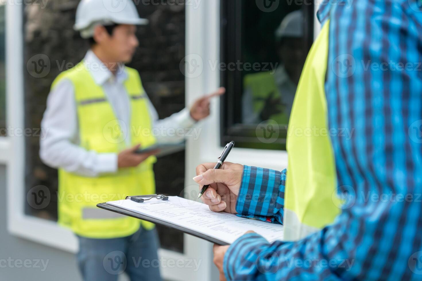 inspector or engineer is inspecting construction and quality assurance new house using a checklist. Engineers or architects or contactor to build the house before handing it over to the homeowner photo