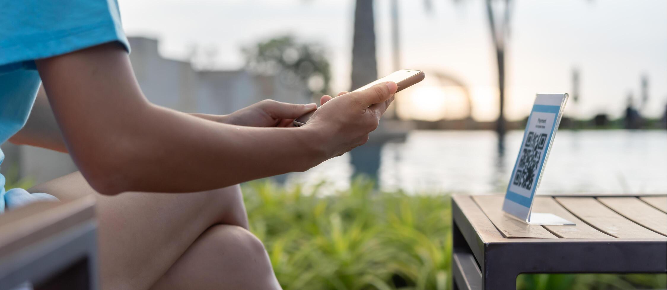Woman use smartphone to scan QR code to pay in cafe restaurant with a digital payment without cash. Choose menu and order accumulate discount. E wallet, technology, pay online, credit card bank app photo