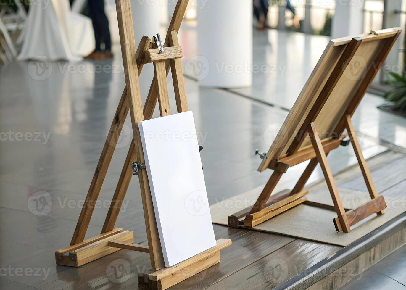Two wooden easels stand ready with blank canvases in a bright airy space awaiting artistic creation photo