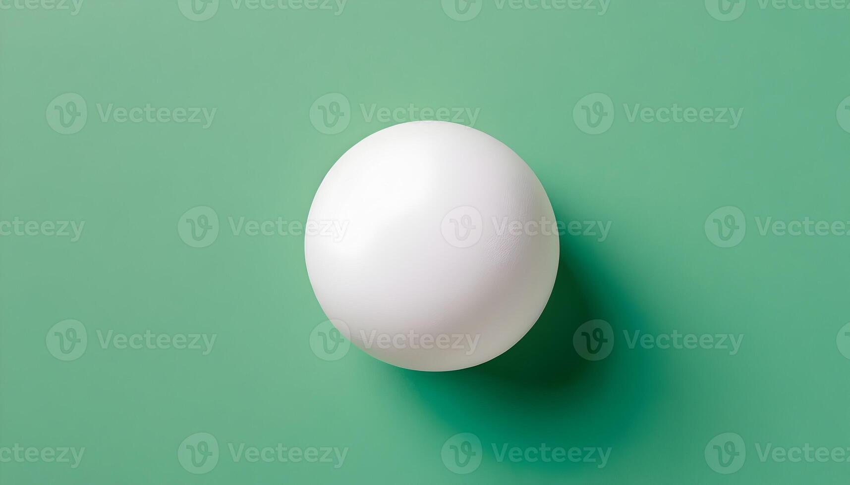White Sphere on Green Background Creating a Simple and Clean Aesthetic photo