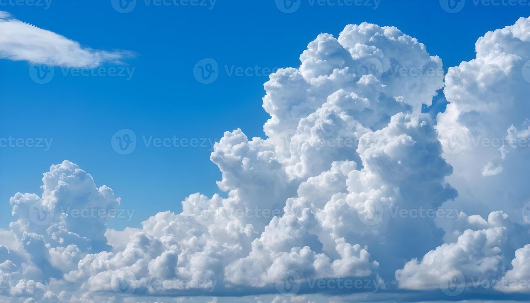 Fluffy Cumulus Clouds Floating in a Clear Blue Sky photo