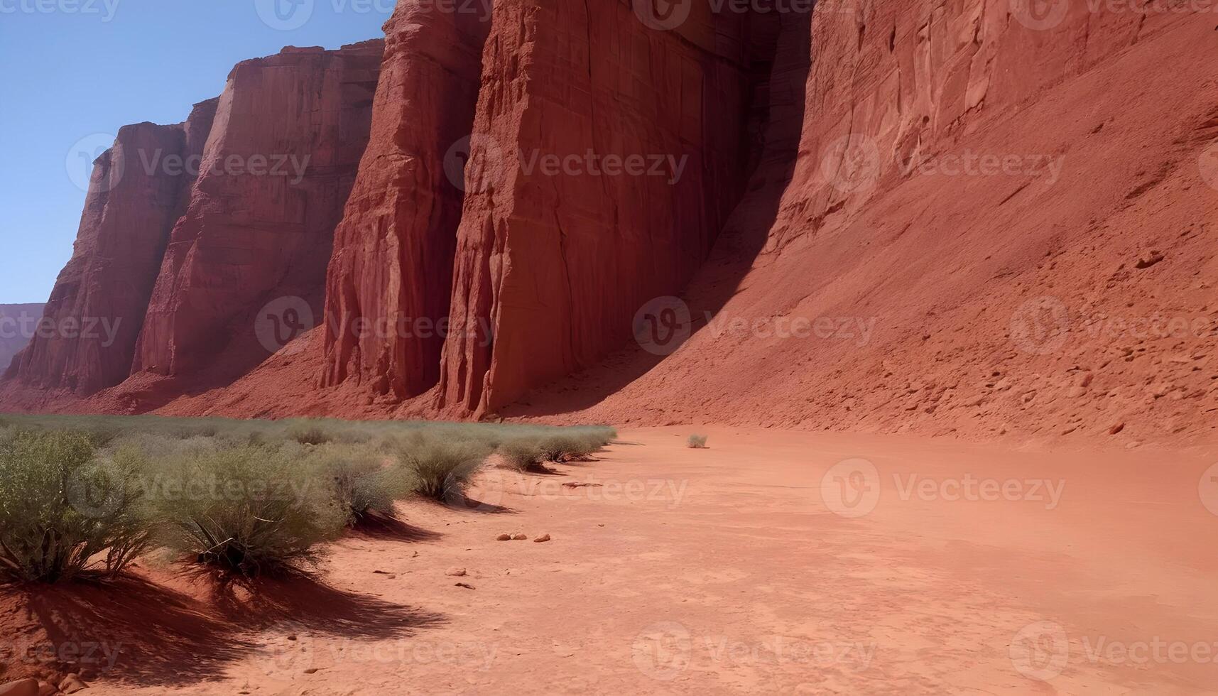 Exploring Vast Desert Landscape with Red Rock Formations and Sparse Vegetation photo
