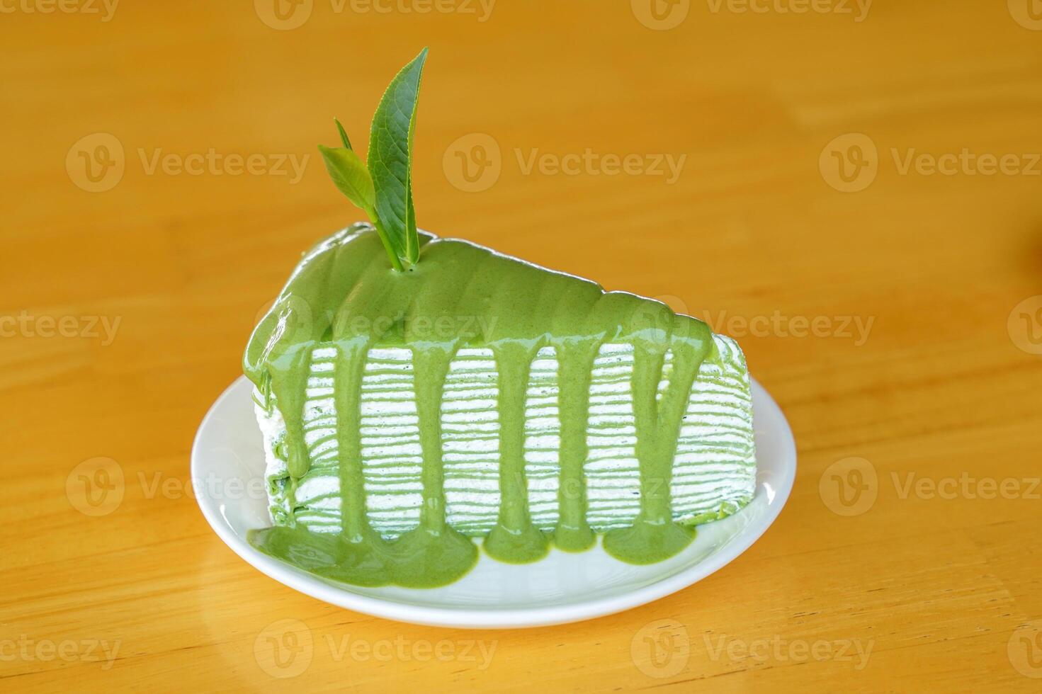 Matcha Crepe Cake is a sweet dessert menu with soft crepe dough, thin layers with a light green tea aroma, arranged alternately with sweet and smooth red bean cream, soft and fluffy. photo