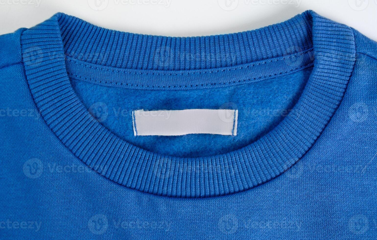 Blank clothing label on a blue sweater photo
