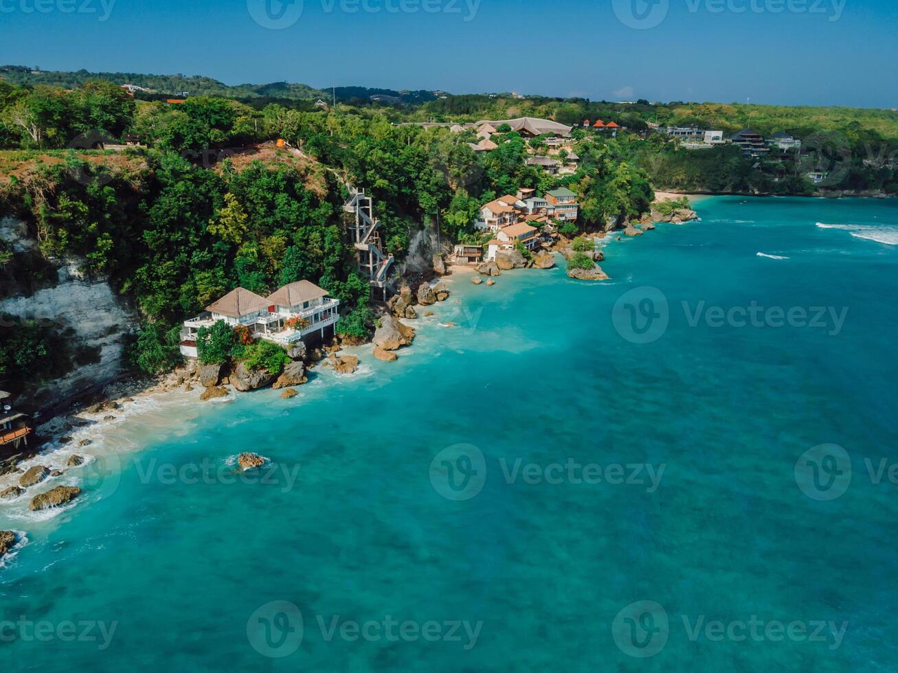 Above view of ocean and cliff coastline with hotels on Impossibles beach in Bali photo