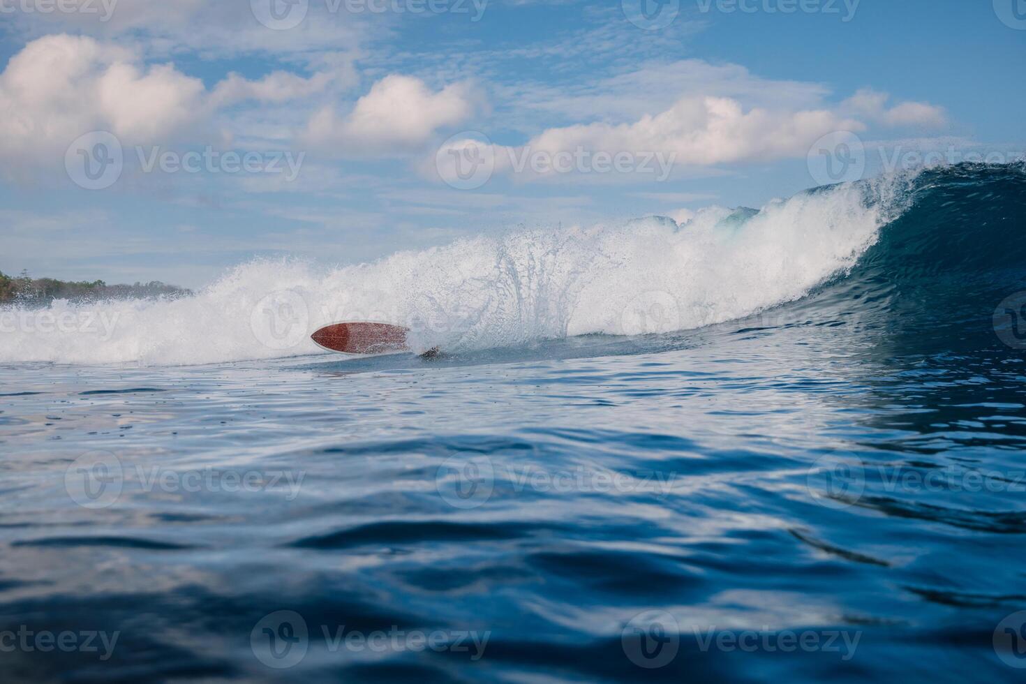 Surfer fell off a swell wave. Wipe out during surfing photo
