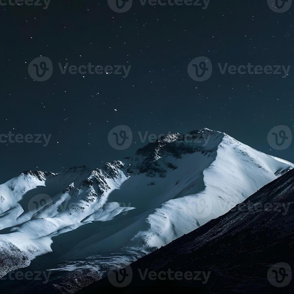 Snowy mountains at night. Mountains top view. photo
