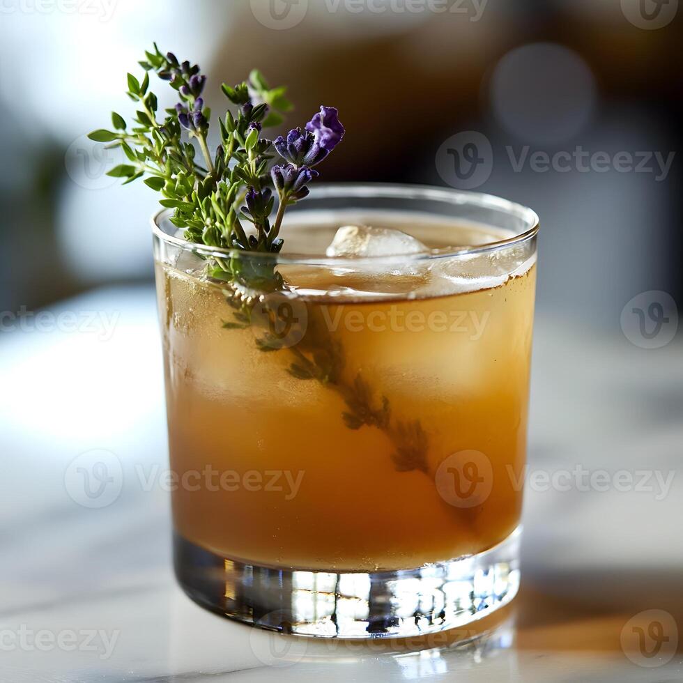 Lemonade with ice and thyme in a glass on the table. herbal tea with mint. photo
