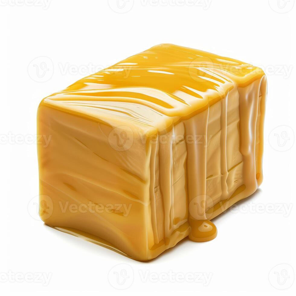 Sweet caramel sauce dripping over a fudge cube on white background photo